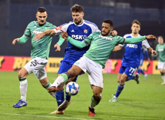 Hajduk – Dinamo prognoza: po 16 bodova, Mišić ne igra, a Hajduk je bez pobjede u šest derbija Igrači Hajduka u zelenim gostujućim dresovima i igrač Dinama u plavom dresu u duelu za loptu na vječnom derbiju
